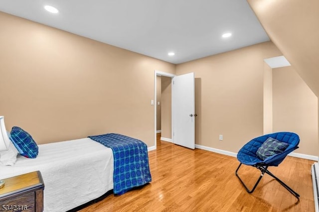 bedroom with recessed lighting, light wood-style flooring, and baseboards