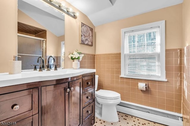 full bath with tile walls, toilet, baseboard heating, a stall shower, and vaulted ceiling