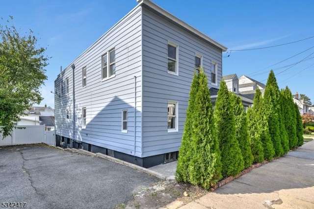 view of home's exterior featuring fence