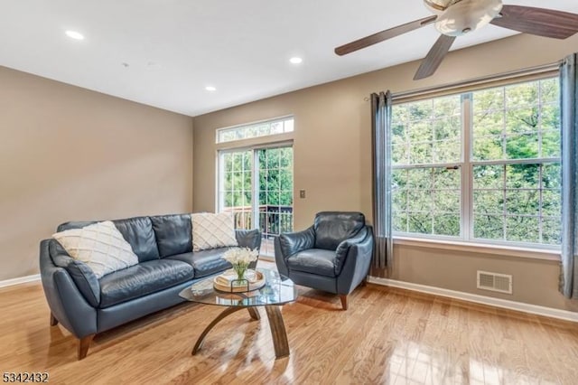 living area with light wood-style floors, baseboards, visible vents, and recessed lighting