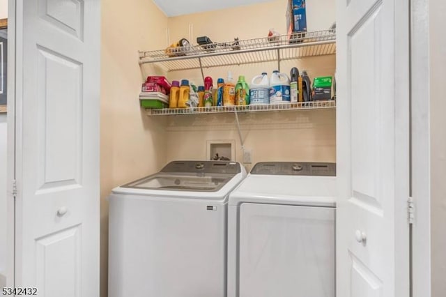 clothes washing area with washer and dryer and laundry area