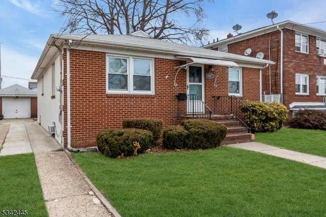 view of front of home with driveway, a detached garage, an outdoor structure, a front lawn, and brick siding