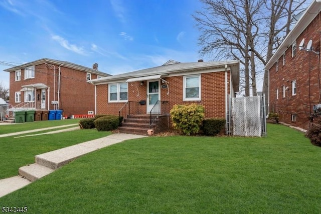 bungalow-style home with a front yard and brick siding