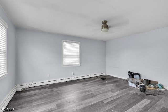 unfurnished room with a baseboard heating unit, ceiling fan, baseboard heating, and wood finished floors