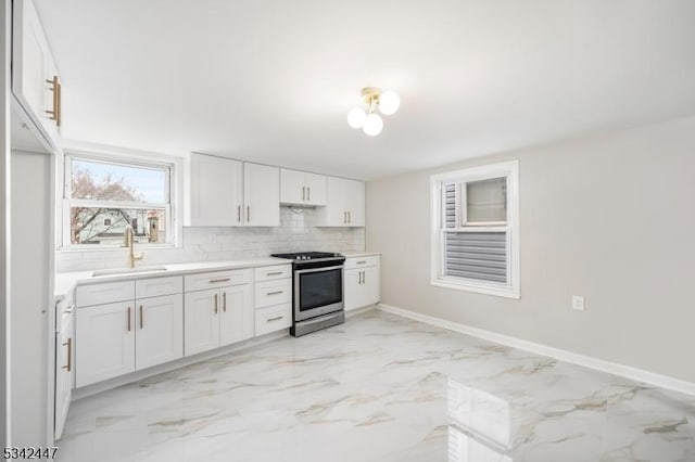 kitchen featuring a sink, white cabinetry, marble finish floor, electric stove, and tasteful backsplash