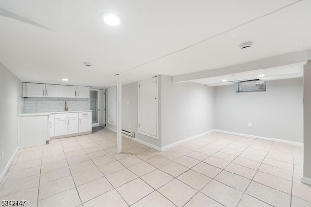 finished below grade area featuring a baseboard radiator, recessed lighting, baseboards, and light tile patterned floors