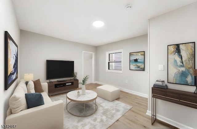 living room with light wood-type flooring and baseboards