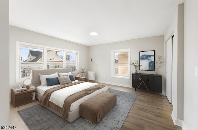 bedroom featuring light wood-type flooring and baseboards