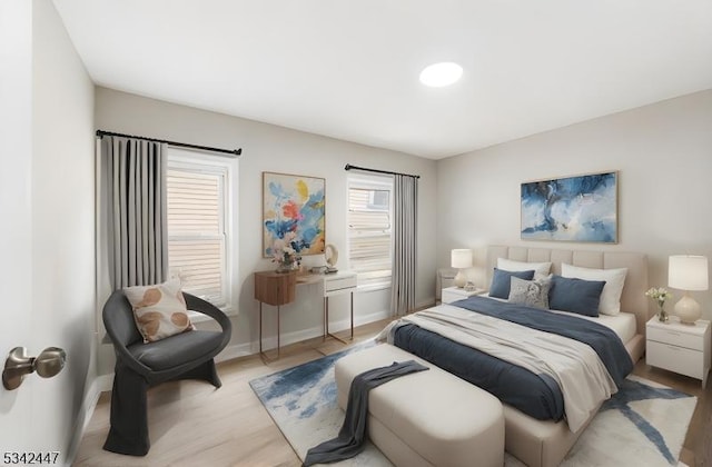 bedroom featuring wood finished floors and baseboards