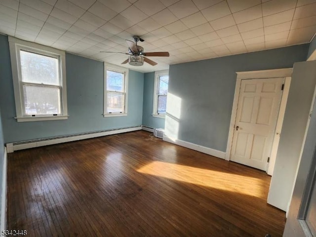 spare room with ceiling fan, a baseboard radiator, wood-type flooring, and baseboards