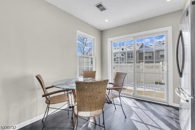 dining space with recessed lighting, wood finished floors, visible vents, and baseboards