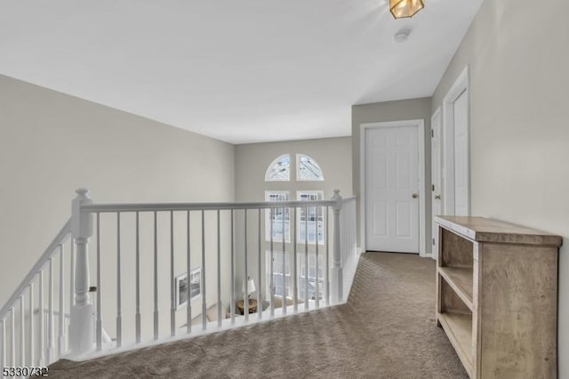 corridor featuring carpet and an upstairs landing