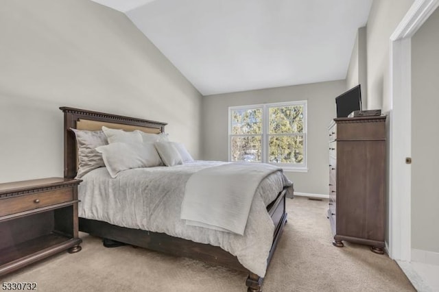 carpeted bedroom featuring baseboards and vaulted ceiling