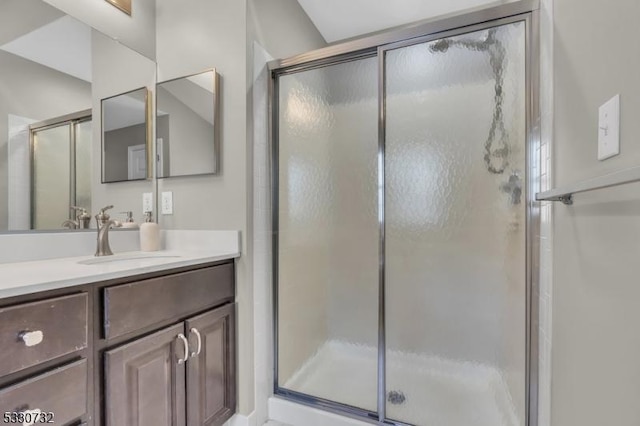 bathroom with a stall shower and vanity