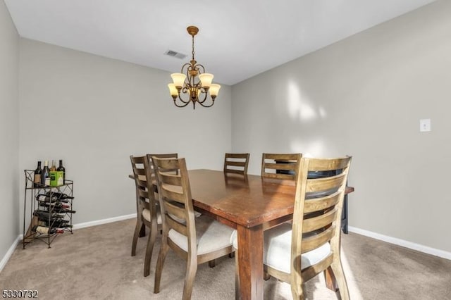 dining space featuring light carpet, baseboards, visible vents, and a notable chandelier