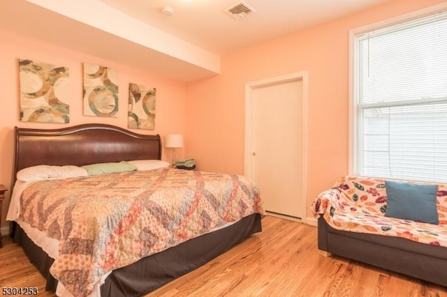 bedroom with visible vents and wood finished floors