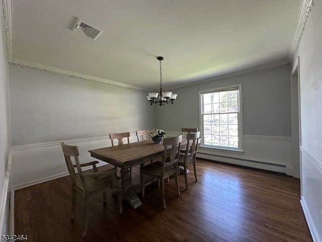 dining area with a baseboard heating unit, dark wood-style floors, visible vents, and ornamental molding