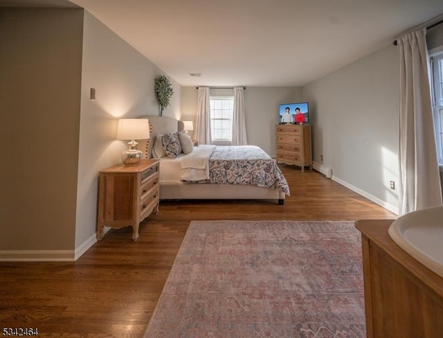 bedroom featuring visible vents, wood finished floors, and baseboards