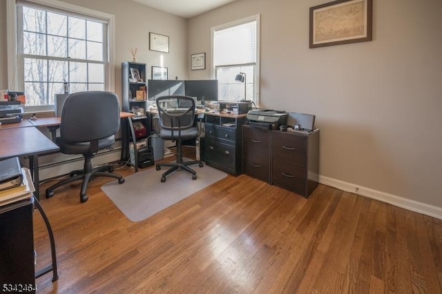 home office with baseboards and light wood-type flooring