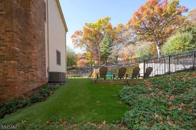 view of yard featuring cooling unit and fence