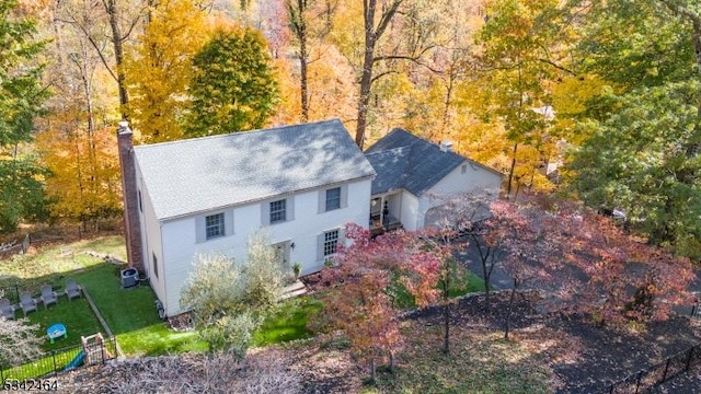 birds eye view of property with a forest view