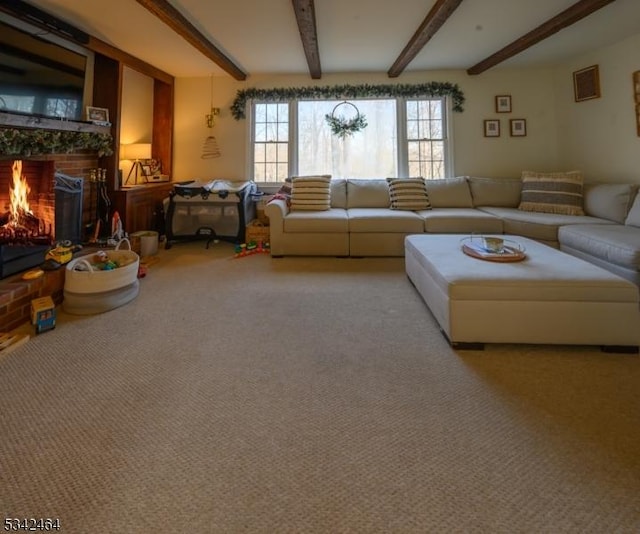 living room featuring beam ceiling, a brick fireplace, and carpet