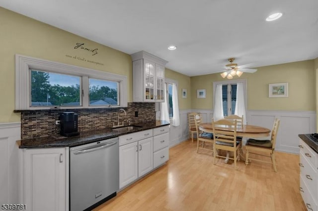 kitchen with ceiling fan, a sink, white cabinets, stainless steel dishwasher, and light wood-type flooring