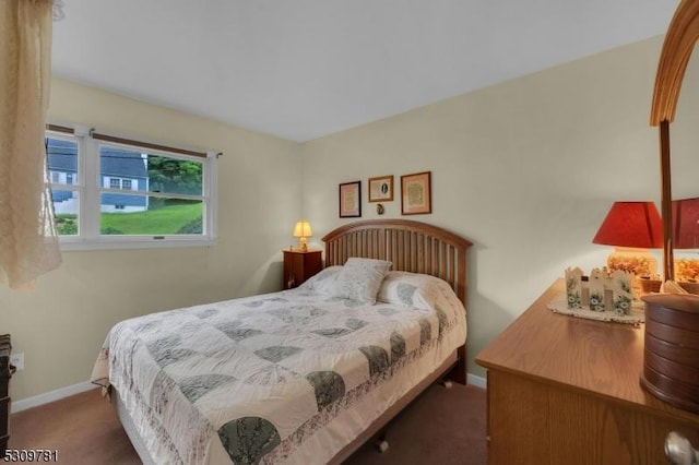 bedroom featuring baseboards and carpet