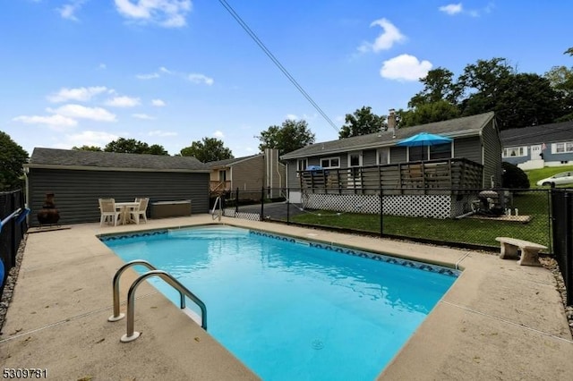 view of swimming pool with a patio area, a fenced in pool, a wooden deck, and a fenced backyard