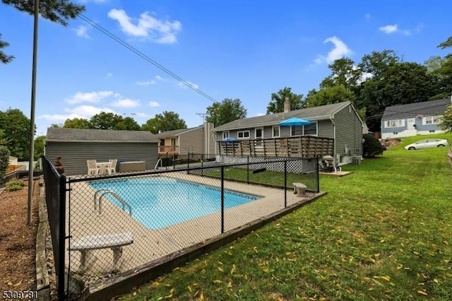 view of pool featuring a wooden deck, a lawn, a fenced in pool, and fence