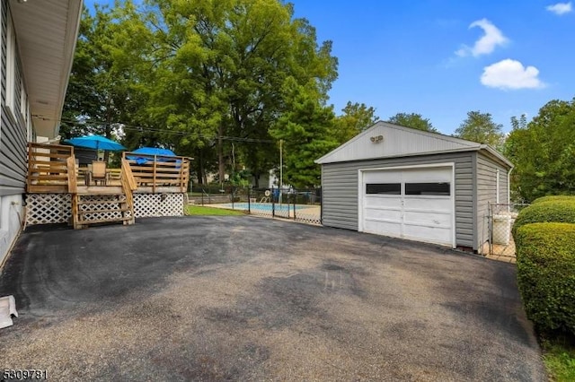 detached garage with driveway and fence