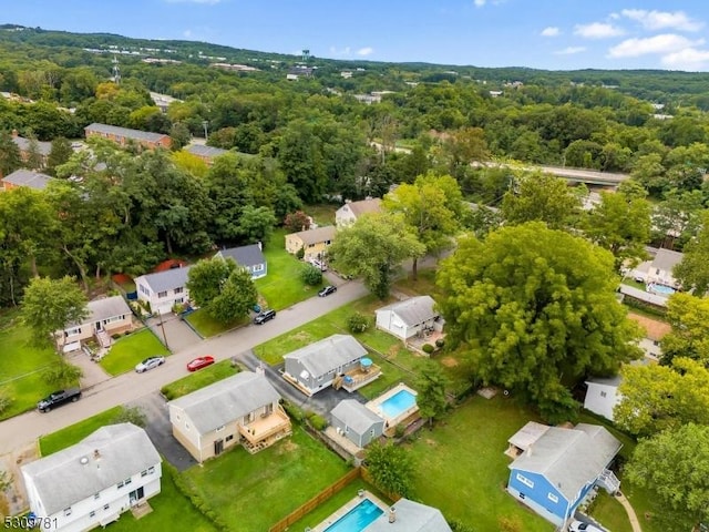 drone / aerial view with a wooded view