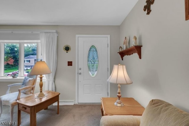 foyer entrance featuring baseboards and carpet floors