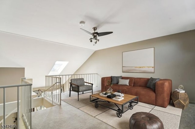 living room with lofted ceiling with skylight, carpet, and a ceiling fan