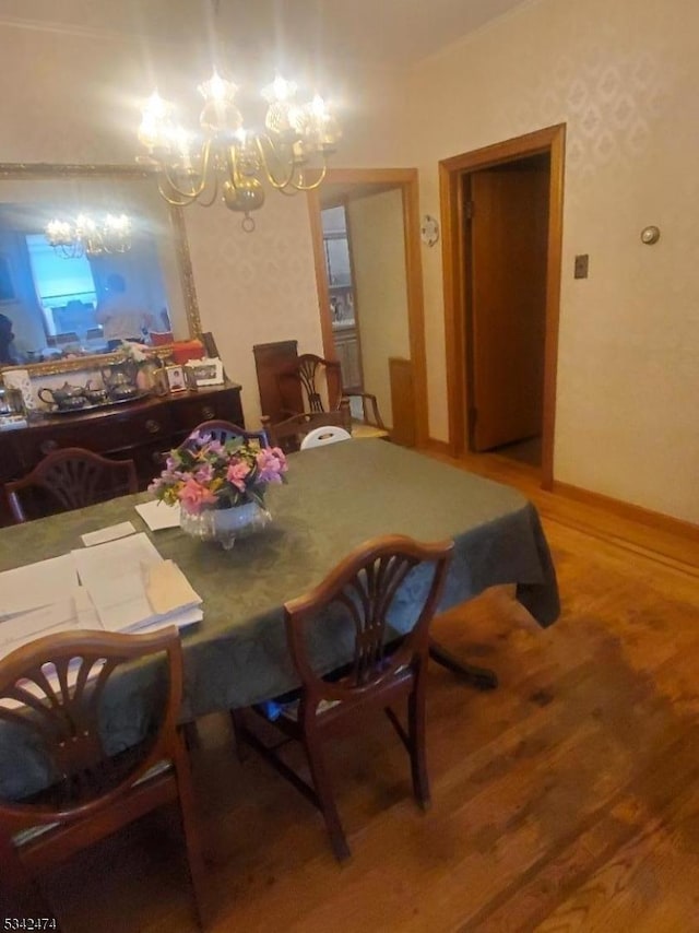 dining room with a notable chandelier and wood finished floors