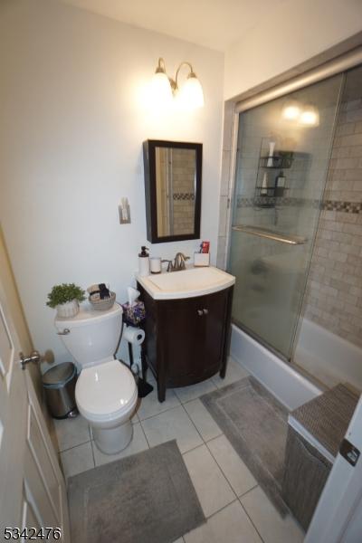 bathroom featuring vanity, toilet, and tile patterned floors