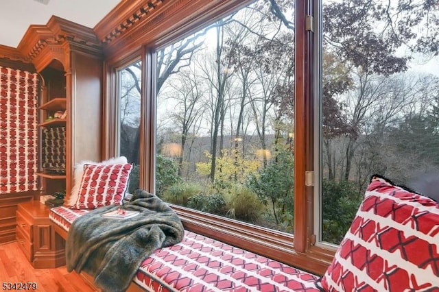 living area featuring crown molding and wood finished floors