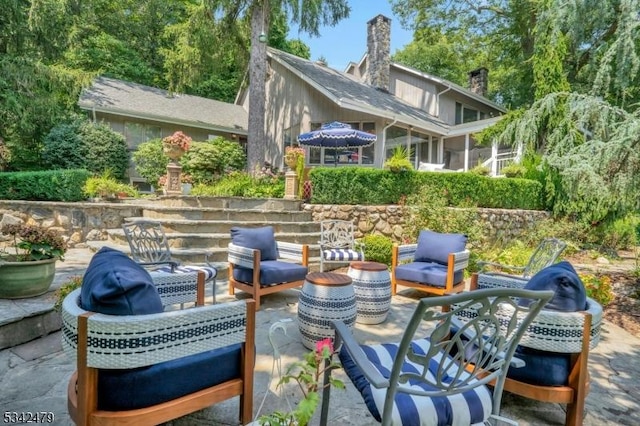 view of patio featuring a sunroom and an outdoor hangout area