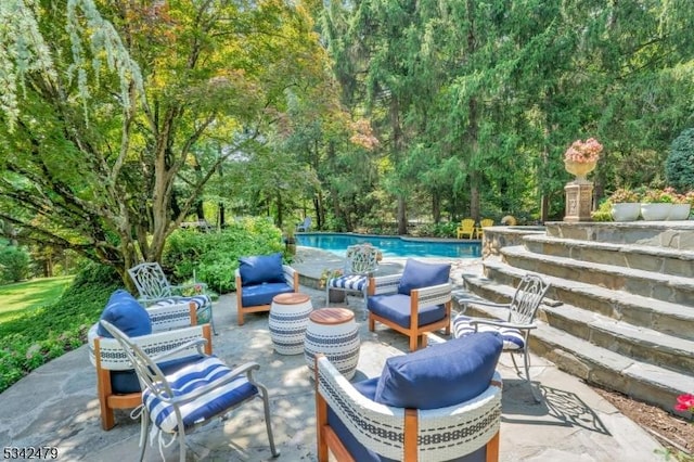 view of patio / terrace featuring an outdoor living space and an outdoor pool