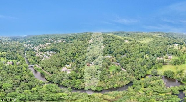 birds eye view of property with a view of trees