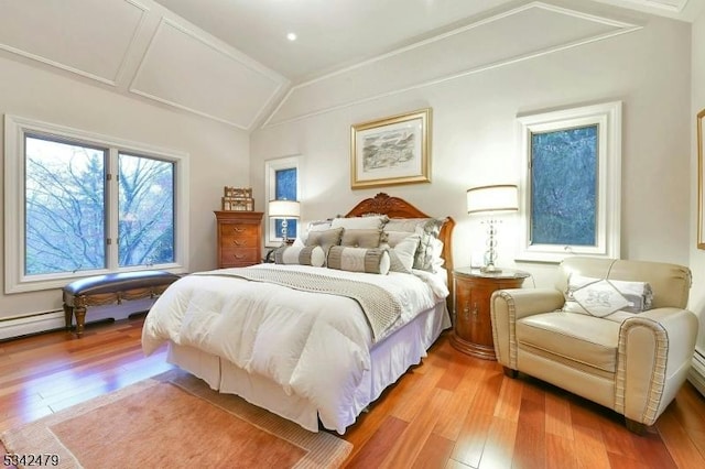 bedroom with lofted ceiling and light wood-type flooring