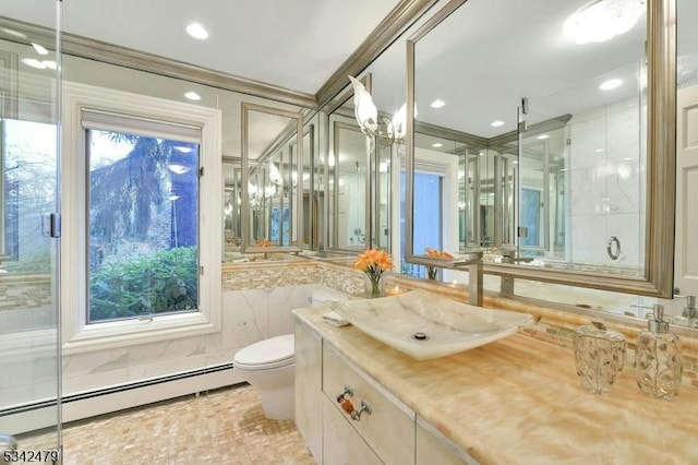 bathroom featuring toilet, baseboard heating, vanity, a shower stall, and tile walls