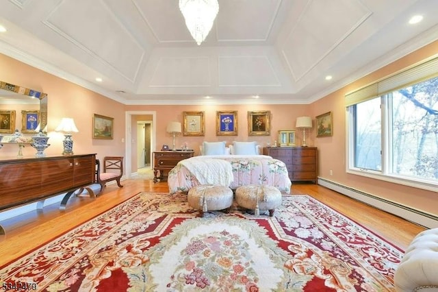 bedroom with an inviting chandelier, a baseboard heating unit, wood finished floors, and ornamental molding