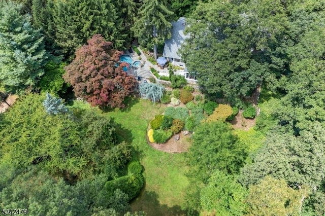 bird's eye view with a wooded view