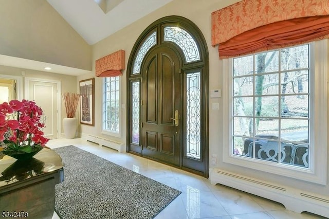 entryway with high vaulted ceiling and a baseboard radiator