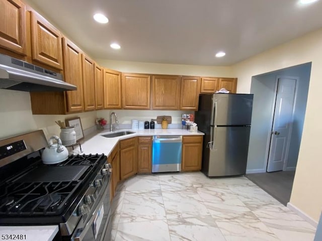 kitchen featuring appliances with stainless steel finishes, marble finish floor, under cabinet range hood, a sink, and recessed lighting