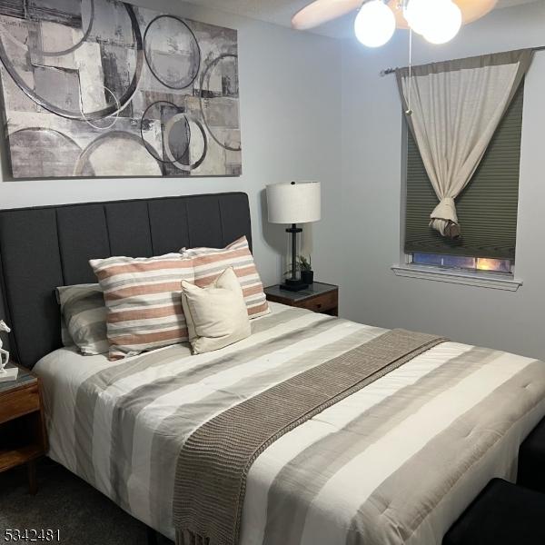 carpeted bedroom featuring ceiling fan