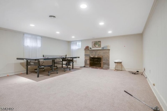 interior space featuring carpet floors, baseboards, visible vents, and a stone fireplace