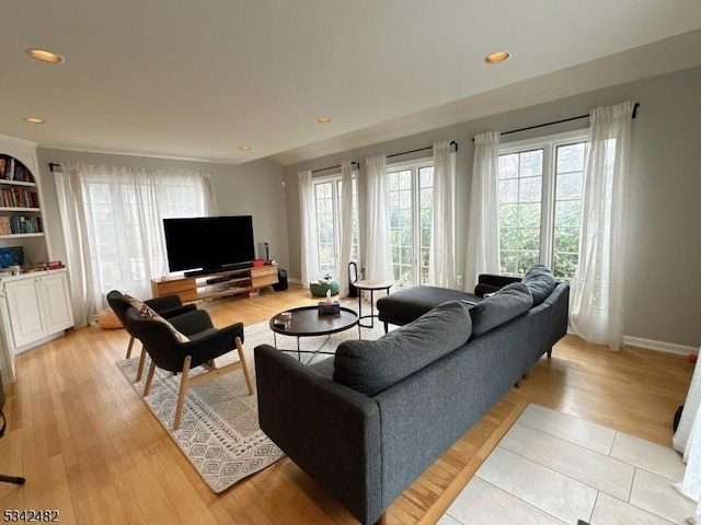 living room with baseboards, recessed lighting, and light wood-style floors