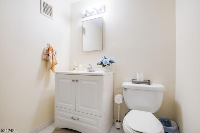 bathroom featuring baseboards, visible vents, vanity, and toilet